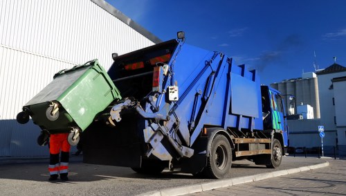 Collection van at a Barking business site next to recycling bins
